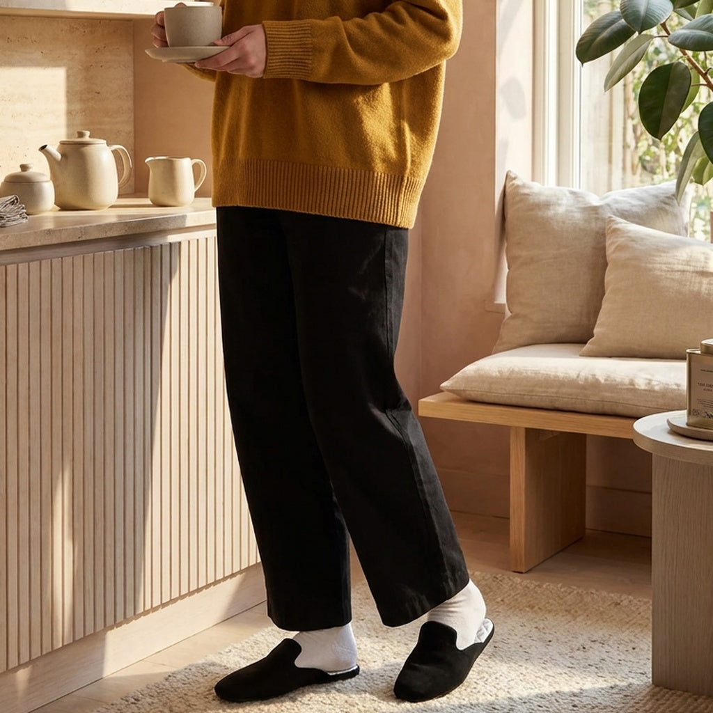 Woman in black leather mule slippers at home