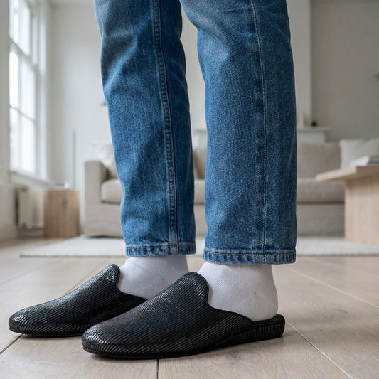 Woman in black leather mule slippers at home