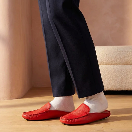 Woman in red leather mule slippers and white socks in a dressing room with oak shelves